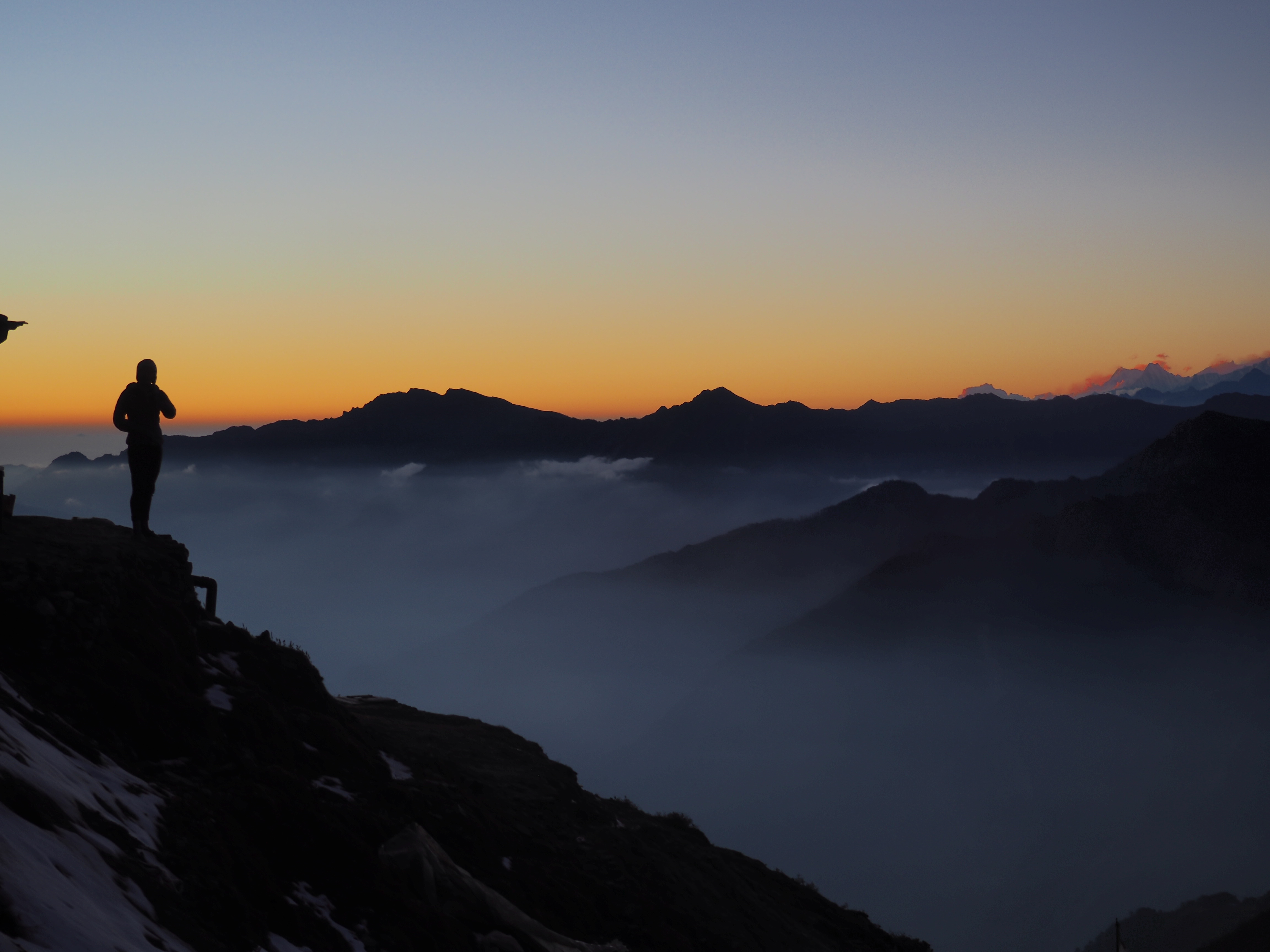 A friend looking out over the mountains during sunset